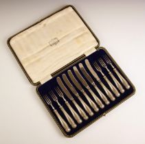 A cased set of silver mounted fruit knives & forks, retailed by Harrods, Harrison Brothers & Howson,