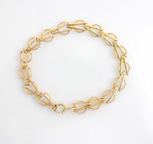 A 9ct yellow gold bracelet, the circular links with arrow head shaped detail to centre, stamped '9.