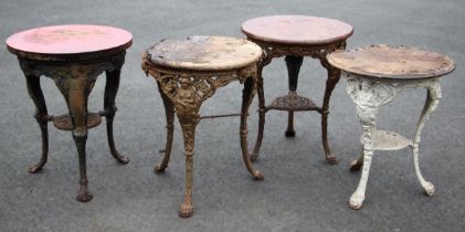 Four cast iron Britannia pub tables, each with a circular hardwood top upon relief cast supports (4)