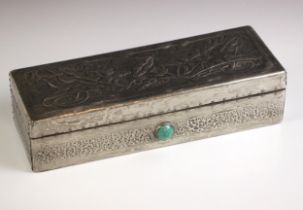 An Art Nouveau pewter covered glove box, the hinged cover embossed with stylised foliage, above an