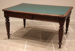A late Victorian oak library table/desk, the skiver inset moulded top with rounded corners, over