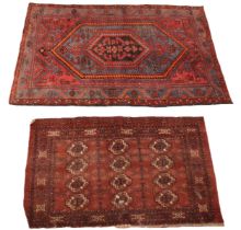 A Caucasian hand knotted village rug, in red, orange and sky blue colourways, centred with graduated