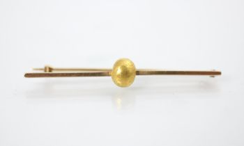 A yellow metal bar brooch, the plain polished bar brooch with applied 'gold nugget', hinge pin to