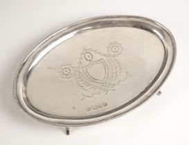 An Edwardian silver teapot stand, Barker Brothers, Chester 1907, the beaded rim enclosing engraved