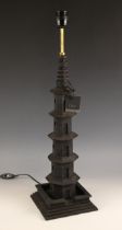 An Oka contemporary carved wooden table lamp, of tapering pagoda form, set to an integral stepped