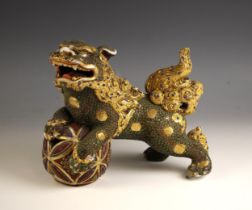 A Japanese satsuma porcelain Dog of Fo, 20th century, modelled standing with its front legs on a