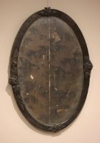 A Jugendstil pewter framed oval wall mirror, the planished frame set with stylised rose motifs, 84cm