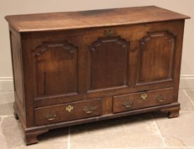 A George III oak mule chest, the hinged cover over three ogee fielded panels and a pair of lip