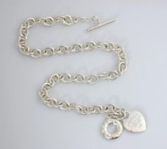 A white metal necklace, in Tiffany and Co style, the trace link chain with heart shaped pendant