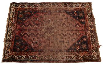 An Iranian Shiraz wool rug, in red, blue and ivory colourways, the central geometric medallion