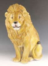 An Italian glazed earthenware lion, of large proportions, 20th century, modelled seated with mouth
