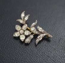 A late 19th century diamond set spray brooch, designed as a flower with old cut diamonds set