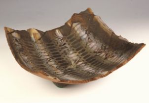 Jim Robison (British, b.1939), a stoneware slab dish, of square form with torn rim, domed feet and