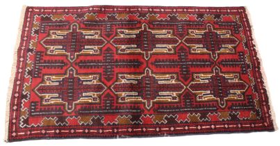 A small Afghan Beluchi tribal rug, unique all over design, in red, blue and brown colourways, the