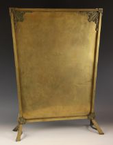 An Art Deco brass fire screen, early 20th century, of tapering form on splayed legs, the corners