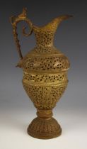 A brass ewer, 20th century, of typical form, the body decorated with birds and figures surrounded by
