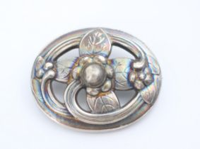 A Georg Jensen silver brooch, the oval openwork brooch with engraved leaf and stylised flower head