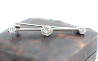 A 20th century diamond set bar brooch, the central old cut diamond within white metal claw set