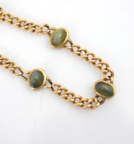 An early 20th century yellow metal bracelet, the curb link bracelet later set with three cabochon