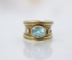 A paste set dress ring, in the manner of Elizabeth Gage, the central oval cut blue stone within