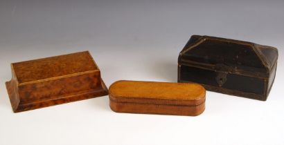 A leather bound cigar case, 20th century, the hinged cover opening to a two division interior,
