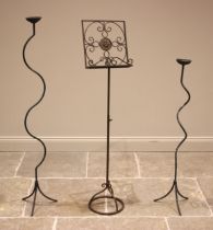 A wrought iron scroll work music stand, 20th century, upon a telescopic stand, extends from 100cm to