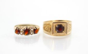 A late 19th century garnet and seed pearl ring, the three graduated oval cut garnets with two seed