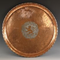 A Hugh Wallis (British, 1871-1943), Arts and Crafts copper charger, of circular planished form, with