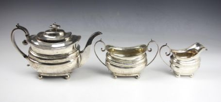 A George III silver three piece tea service, Naphtali Hart, London 1812, comprising teapot, sugar