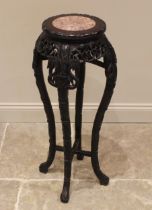 A Chinese carved hardwood and rouge marble jardinière stand, early 20th century, the circular top