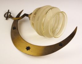 A 1940s brass and glass light fitting, modelled as a crescent moon with applied stars, suspending