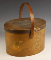 A bentwood hatbox, 20th century, of typical form with serrated joined edge and swing handle, the