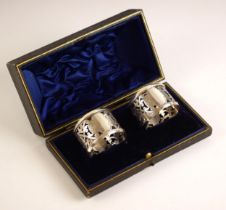 A pair of cased Edwardian silver napkin rings, Levi and Salaman, Birmingham 1910, the openwork