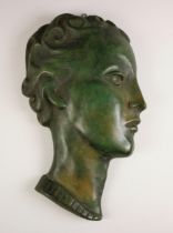 An Art Deco style portrait wall plaque in the manner of Goldscheider, 20th century, the bronze and