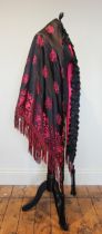 A 1920s shawl/mantle, made from a 19th century shawl, of black and raspberry coloured silk, lined