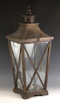 A glazed stained wood 'lantern' display case, late 20th century, the hinged pagoda form top over a
