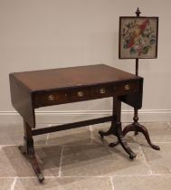 A Regency style mahogany sofa table, the drop leaf top with a reeded edge over a pair of frieze