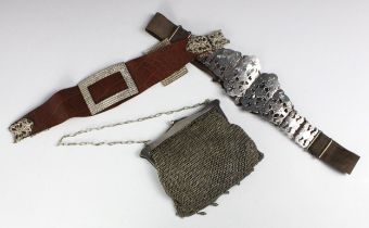 An Edwardian silver plated and leather belt, of floral design, and another white metal and leather