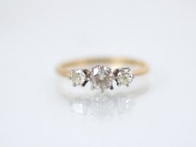 A 20th century diamond three stone ring, the central round cut diamond with smaller round cut