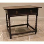 An 18th century oak side table, the cleated plank top over a single oak lined frieze drawer, upon