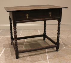 An 18th century oak side table, the cleated plank top over a single oak lined frieze drawer, upon