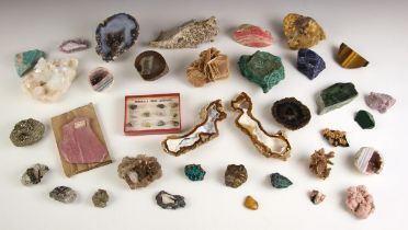 A selection of rock specimens and minerals, of various sizes, including a black obsidian example,