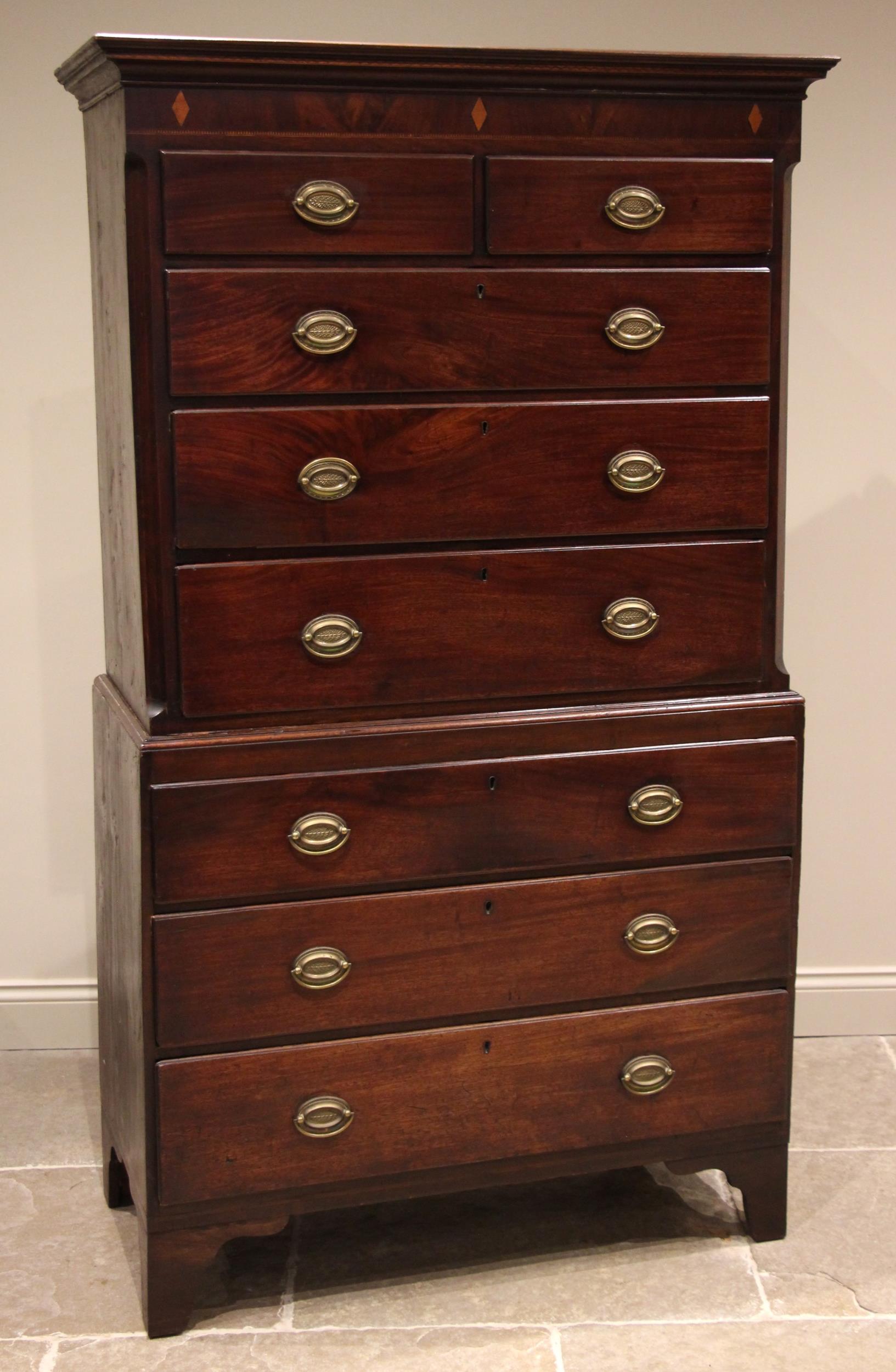 A George III mahogany chest on chest, the moulded cornice over a frieze inlaid with satinwood