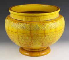 A yellow glazed stoneware jardiniere, early 20th century, the body with foliate and geometric