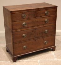 A late George III oak twin section chest of drawers, formed with two short over three long graduated