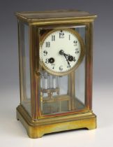 A French four glass mantel clock, early 20th century, the bevelled glass case enclosing a 9cm dial