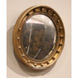 A Regency style giltwood and gesso convex wall mirror, late 19th century, the moulded frame