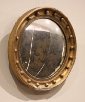 A Regency style giltwood and gesso convex wall mirror, late 19th century, the moulded frame