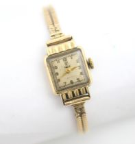 A yellow metal ladies Tudor wristwatch, the square dial with Arabic numerals, set to a plain