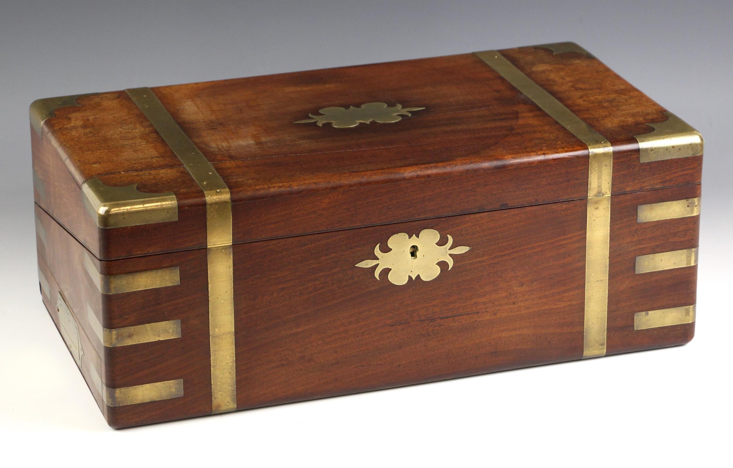 A 19th century mahogany brass bound stationery box, applied with a shaped brass cartouche,